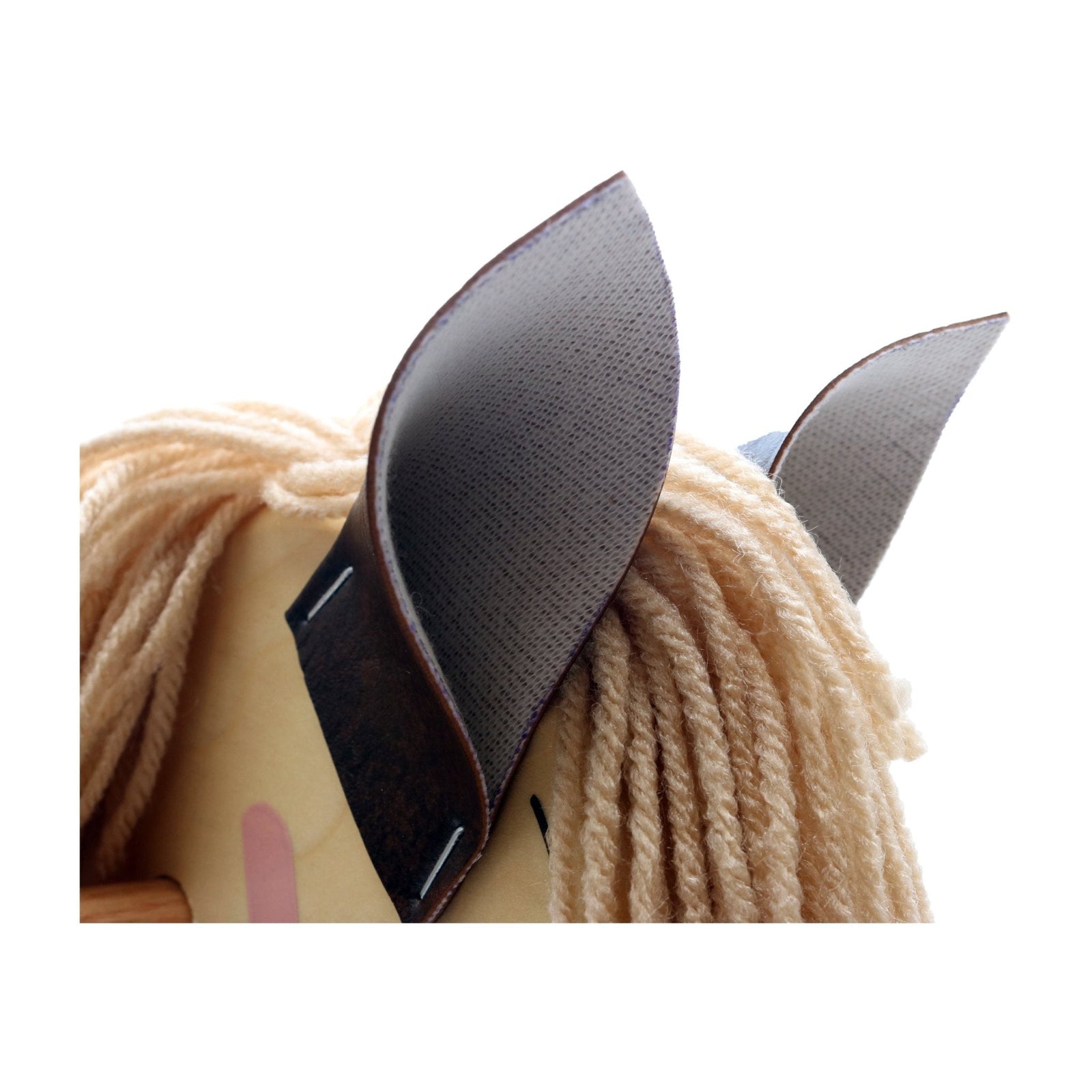 Close-up of black ears and yarn mane on wooden rocking horse