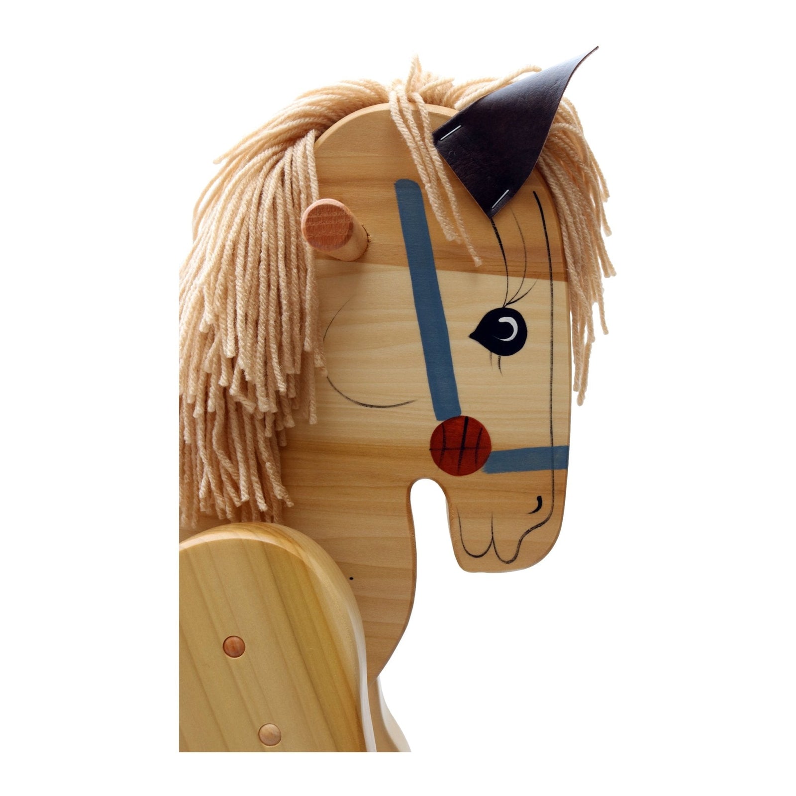 Close-up of wooden rocking horse face and yarn mane
