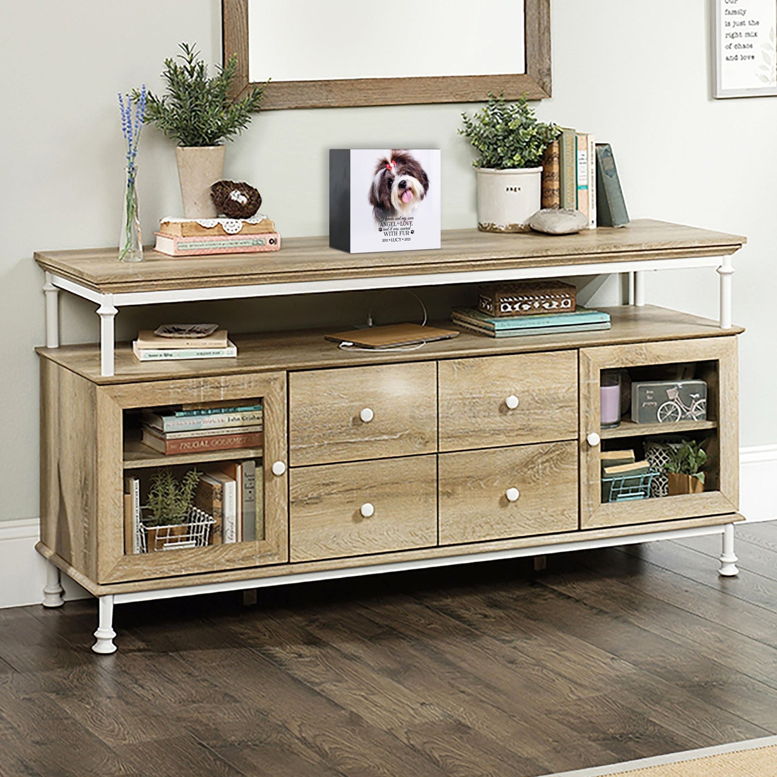 A personalized pet urn placed on a rustic console table.