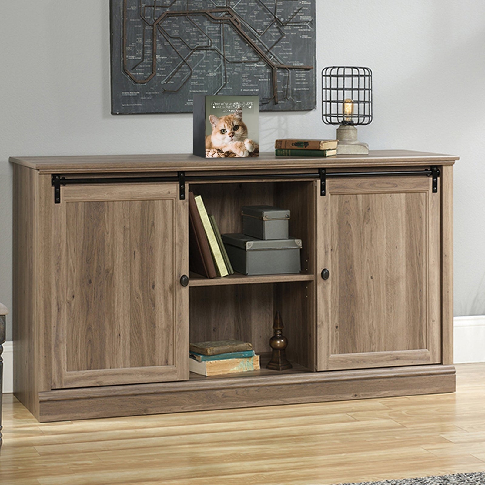 Custom wooden pet urn shadow box displayed on a rustic wooden cabinet in a cozy living room.