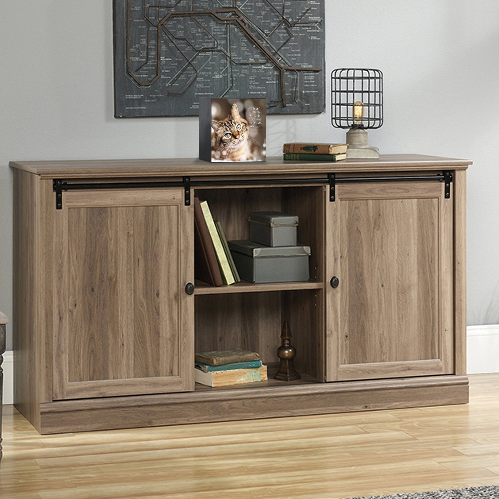 Custom wooden pet urn shadow box displayed on a rustic wooden cabinet in a cozy living room.