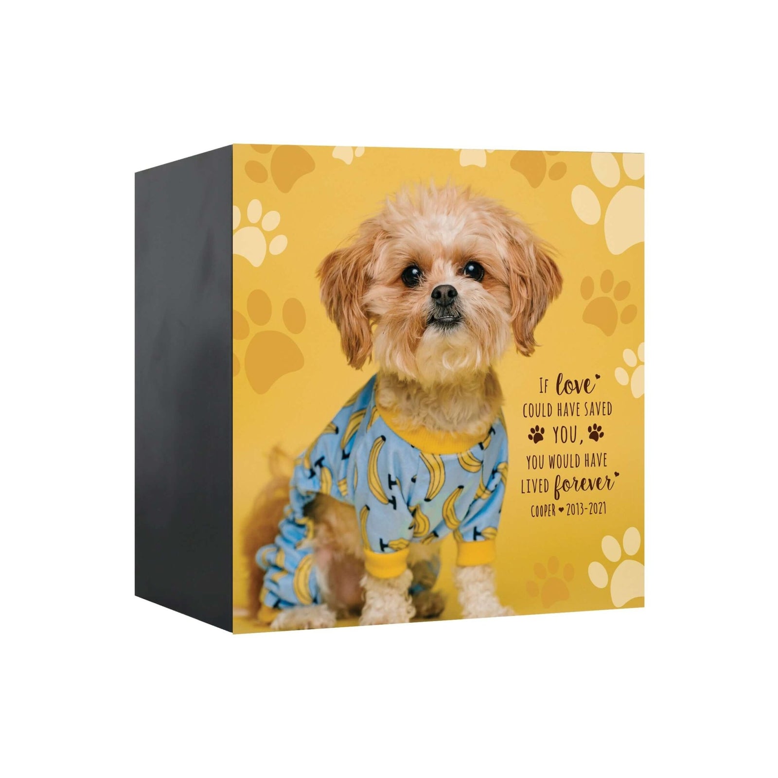 Photo Keepsake Urns for Pets Ashes with a dog wearing a banana-print outfit, set against a yellow background with paw prints, displaying a sentimental quote.