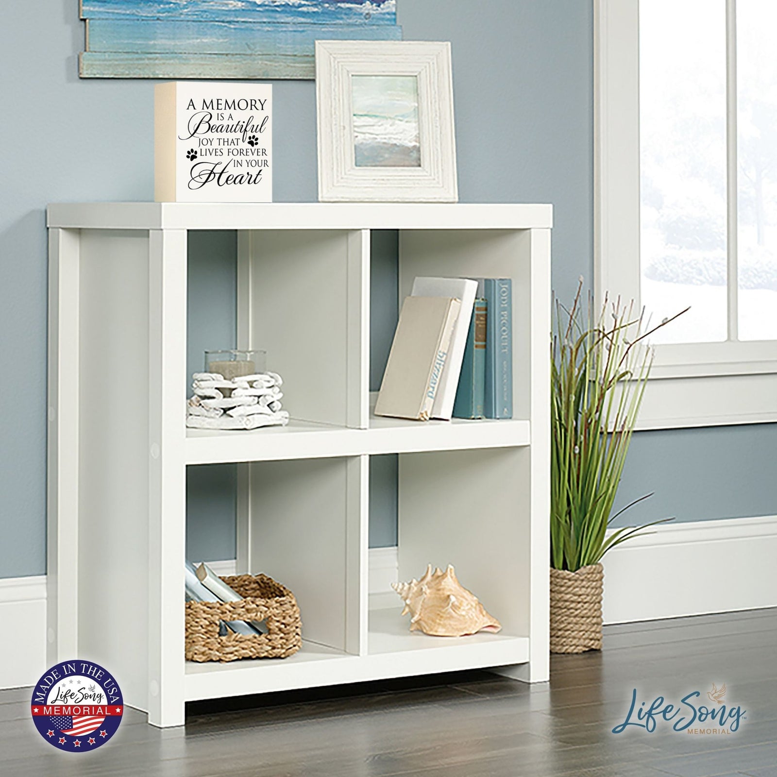 Lifesong Milestones Memorial Shadow Box Urn For Pet Ashes in white, displayed on a stylish shelf with coastal décor, reminding pet owners of the everlasting joy and love their furry friend brought into their lives.