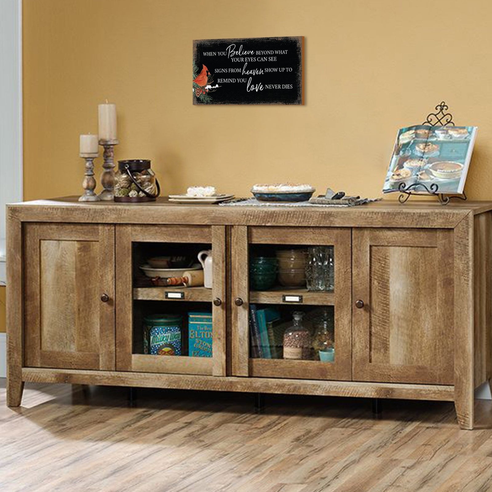 A wooden memorial wall plaque featuring a cardinal, a symbol of remembrance and love.