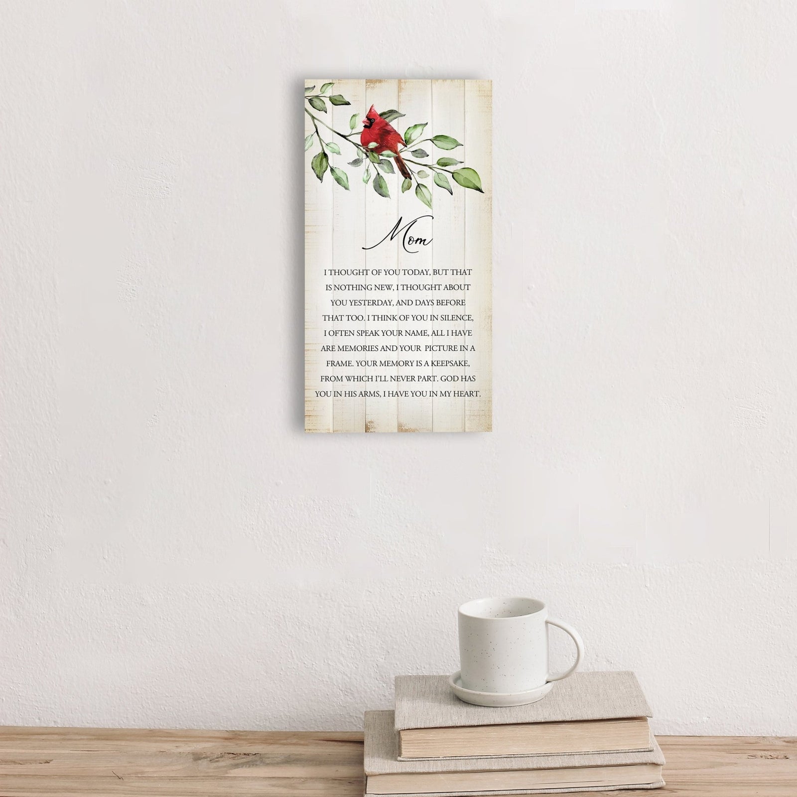 A wooden memorial wall plaque featuring a cardinal, a symbol of remembrance and love.