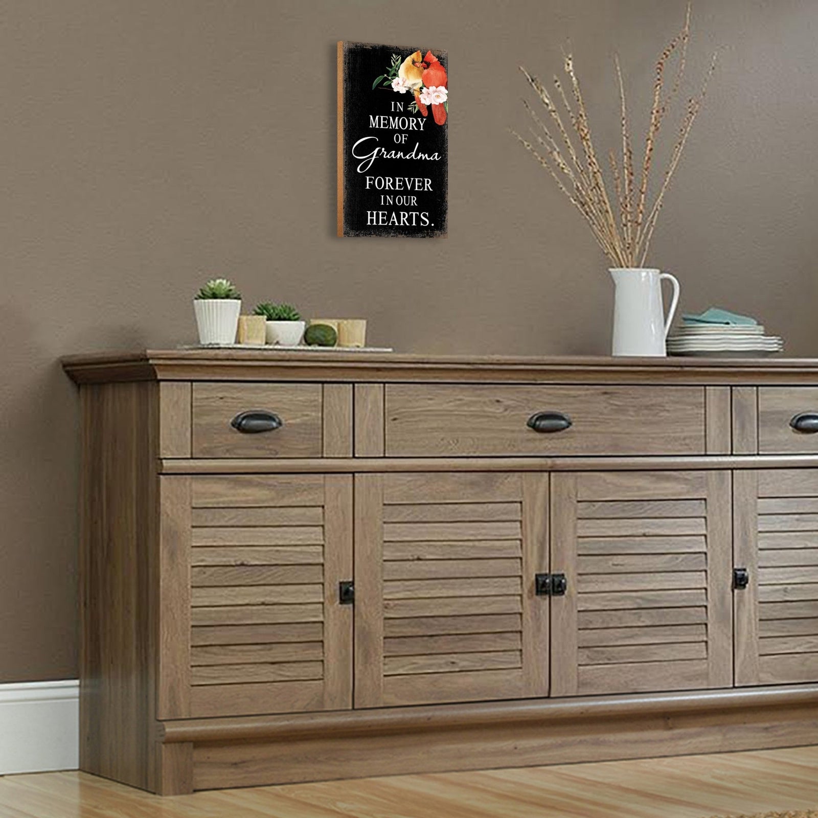 A wooden memorial wall plaque featuring a cardinal, a symbol of remembrance and love.