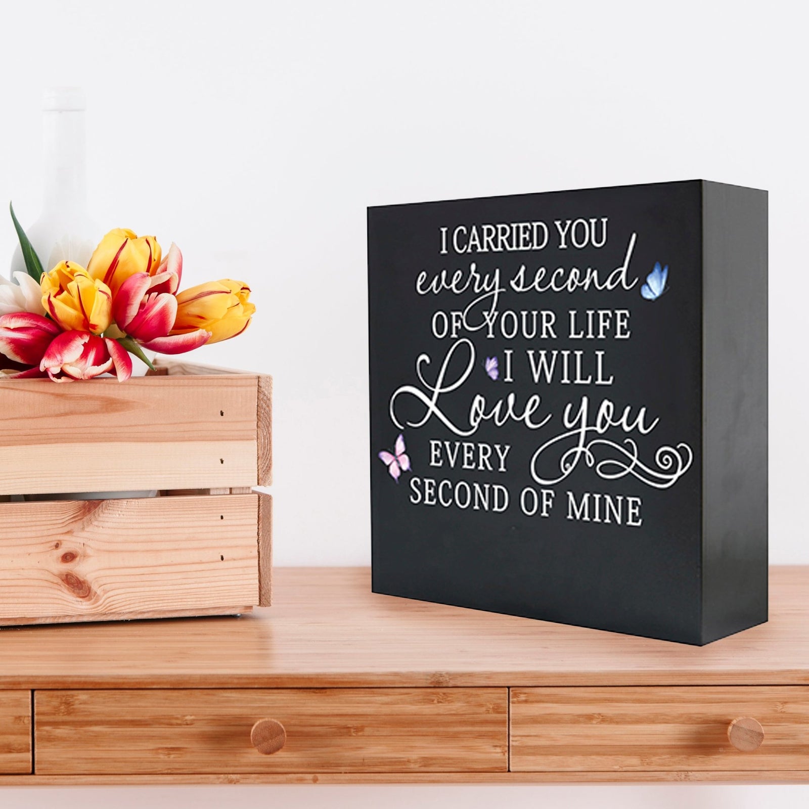 Lifesong Milestones Memorial Shadow Box Urn for human ashes, featuring a black wooden design with an elegant inscription reading, 'I carried you every second of your life, and I will love you every second of mine.' Beautifully decorated with colorful butterfly accents, perfect as a remembrance piece for loved ones.