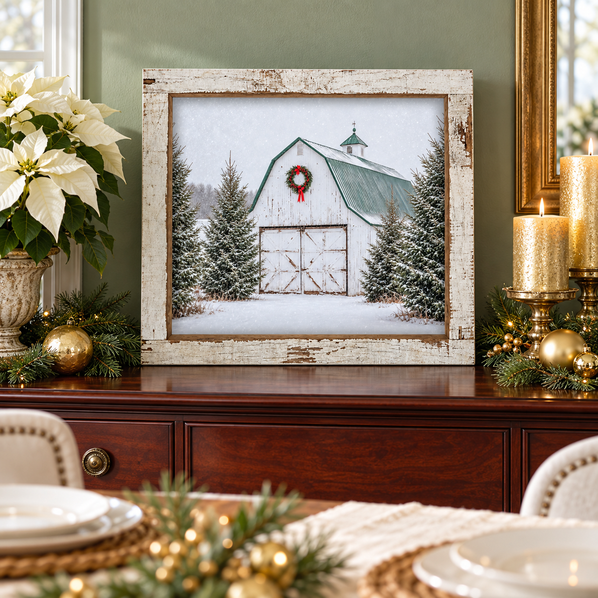 White barn Christmas wall sign with a red-bow wreath, green roof, and snowy spruce trees in a 16 x 16 inch distressed white barnwood frame