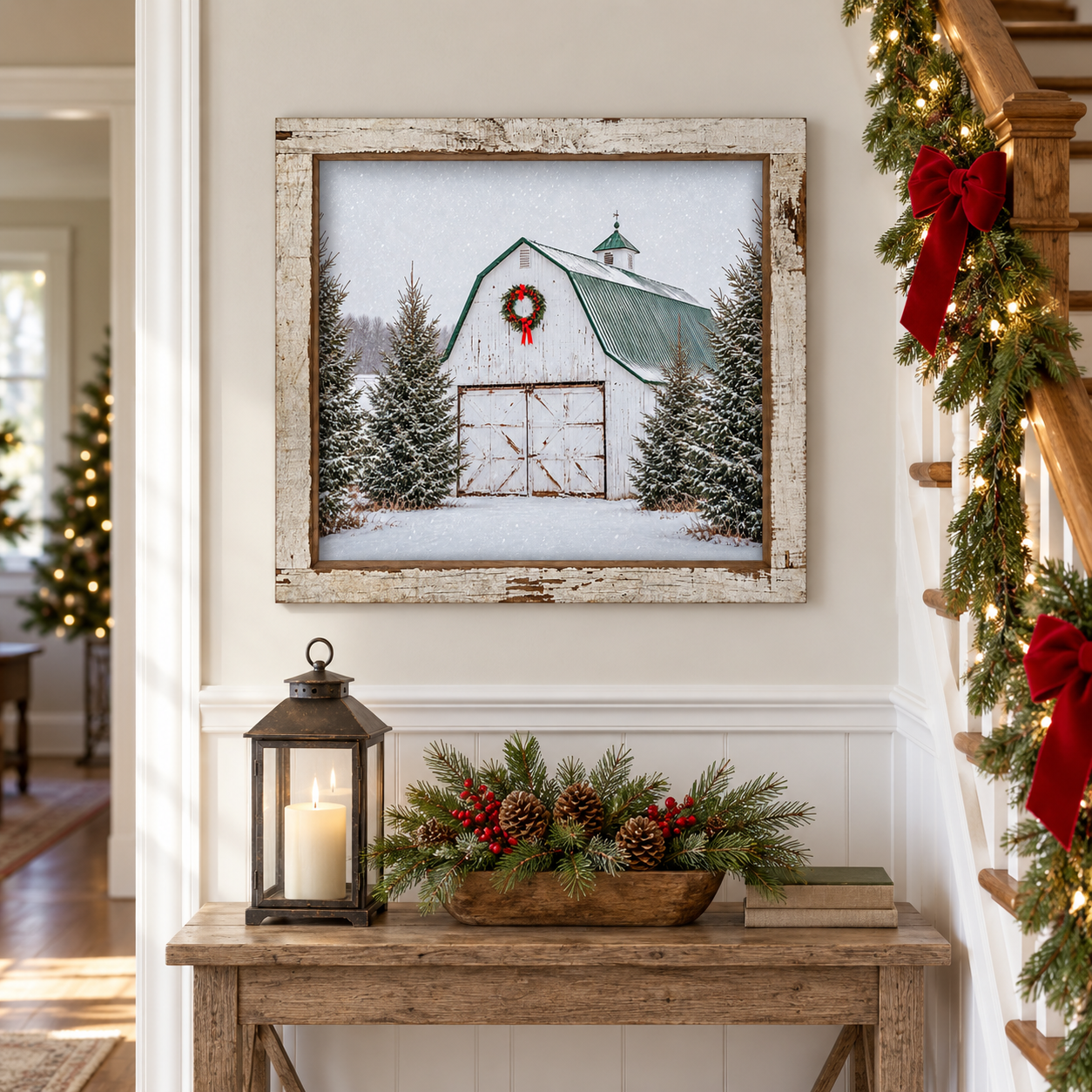 White barn Christmas wall sign with a red-bow wreath, green roof, and snowy spruce trees in a 16 x 16 inch distressed white barnwood frame