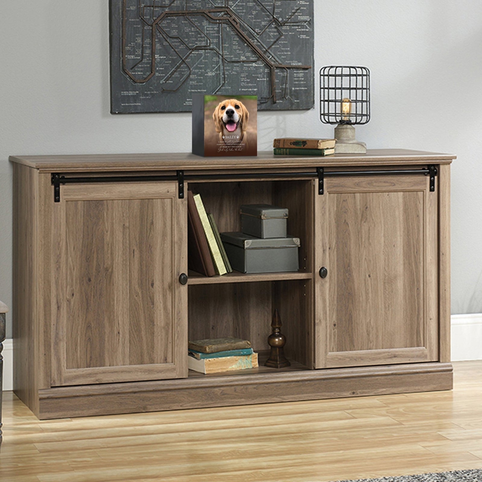 Custom wooden pet urn shadow box displayed on a rustic wooden cabinet in a cozy living room. The personalized pet memorial shadow box features a customized photo of a pet and a heartfelt message. A perfect bereavement keepsake box and sympathy gift for honoring the loss of a beloved pet, blending warmth and sentiment with home décor.