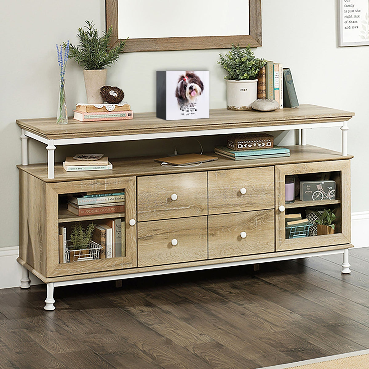 A personalized pet urn placed on a rustic console table.