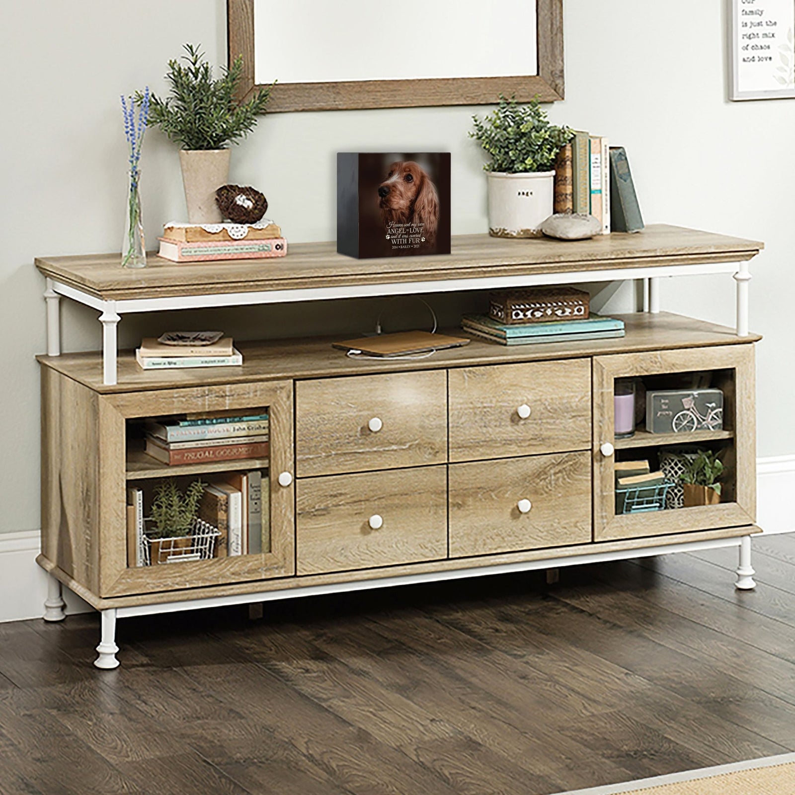A personalized pet urn placed on a rustic console table.