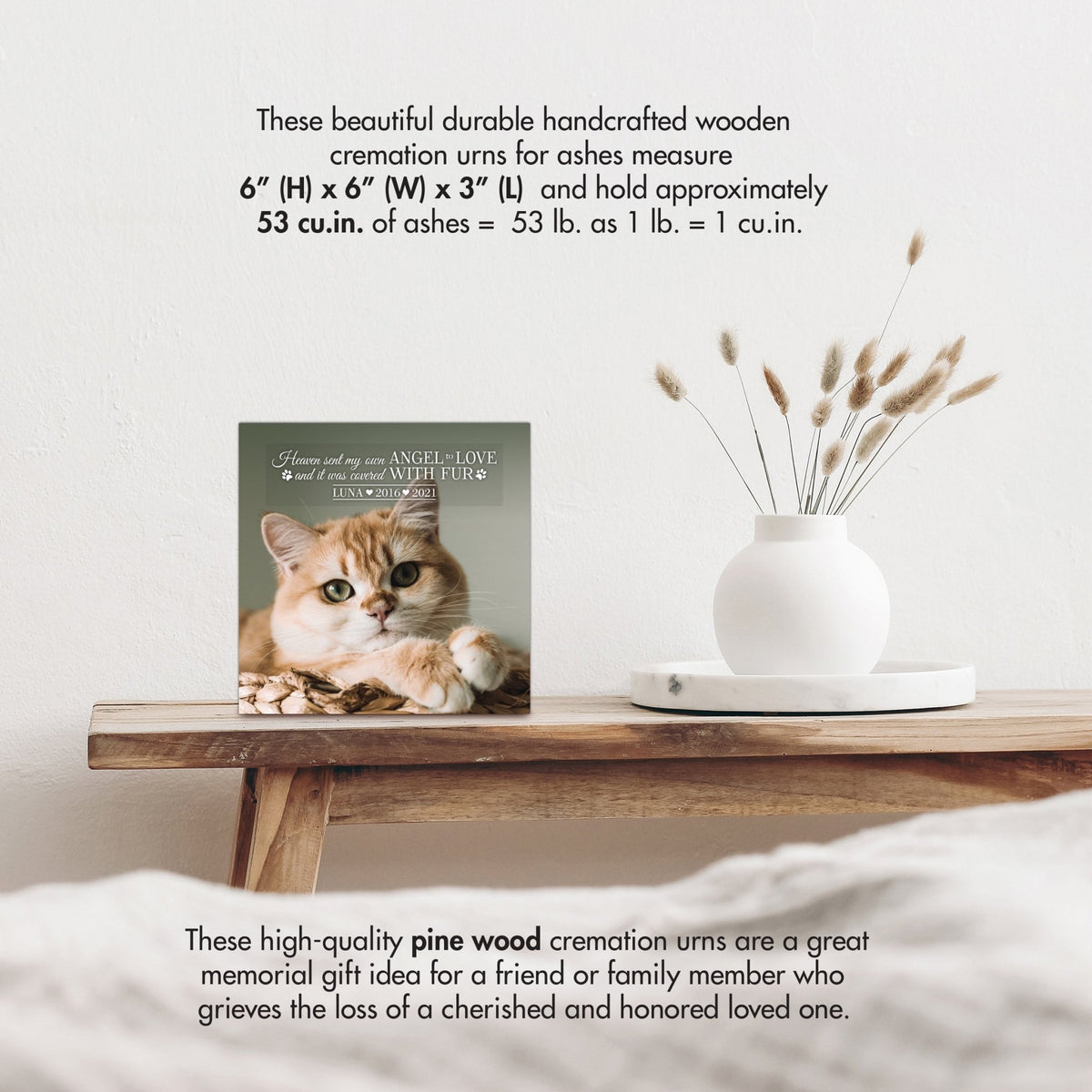 Wooden pet urn shadow box by Lifesong Milestones displayed on a rustic wooden table with a white vase of pampas grass.