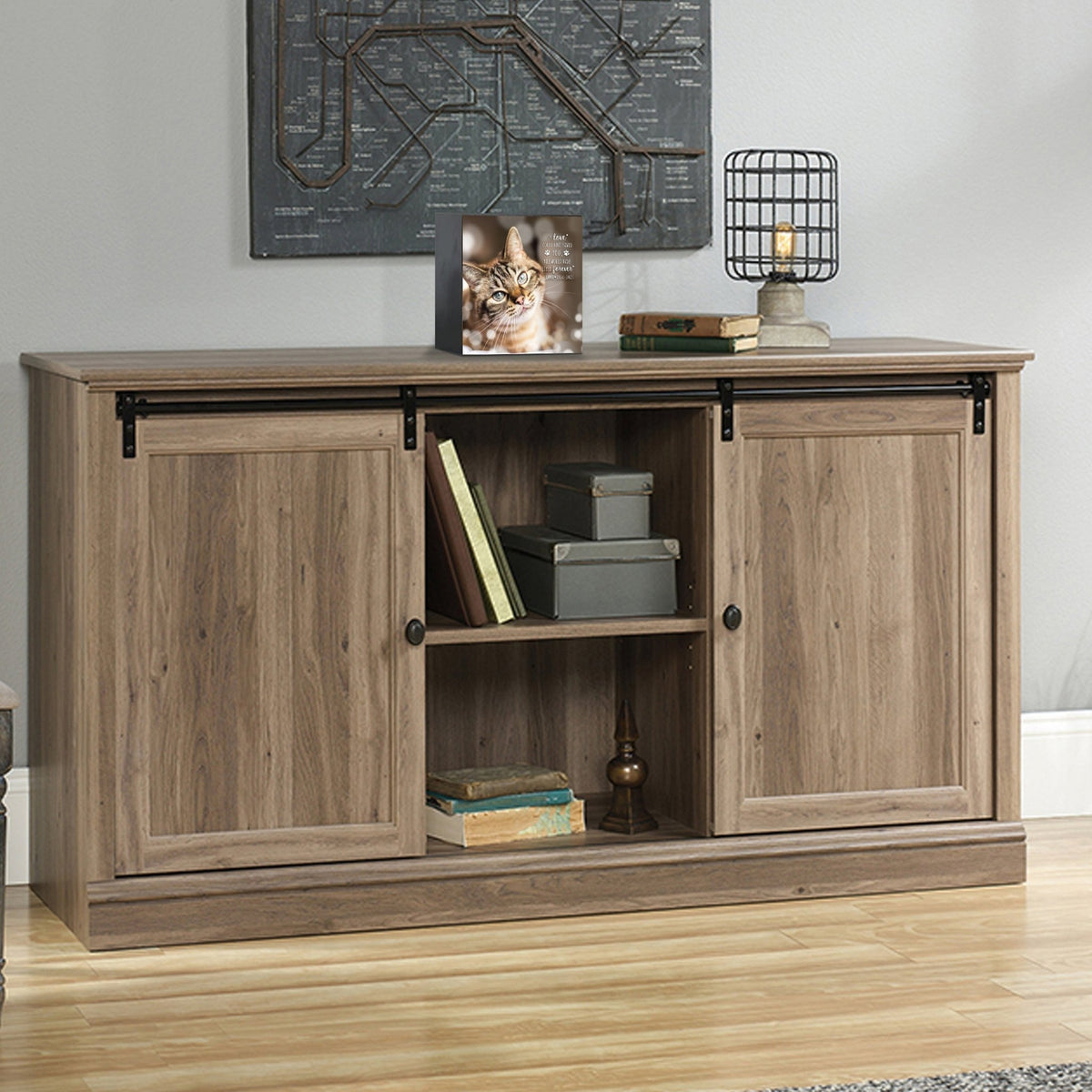 Custom wooden pet urn shadow box displayed on a rustic wooden cabinet in a cozy living room.