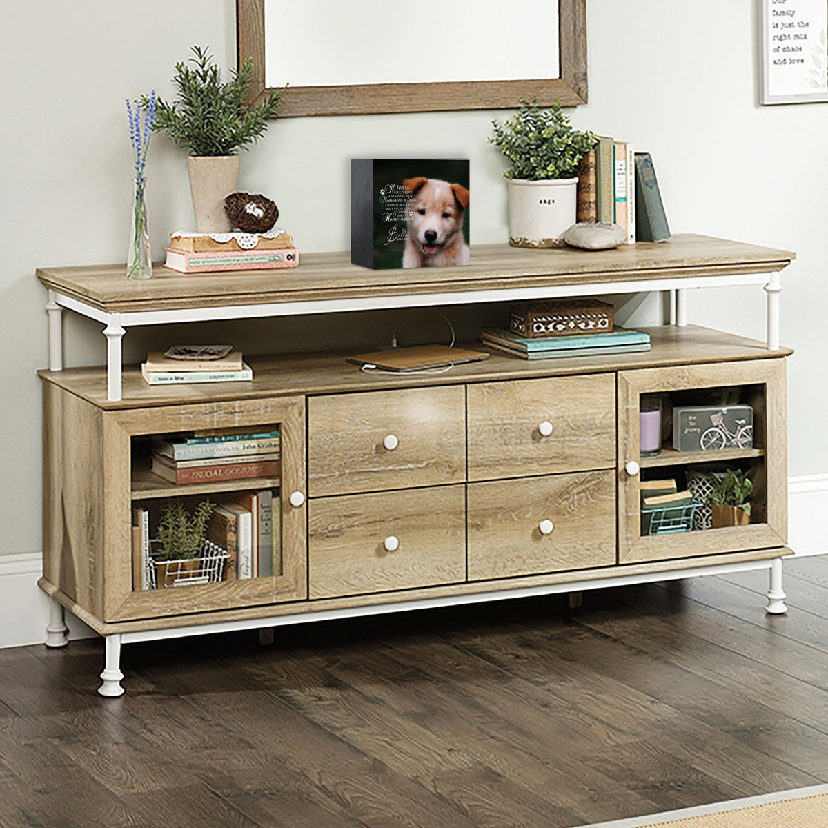 A personalized pet urn placed on a rustic console table.