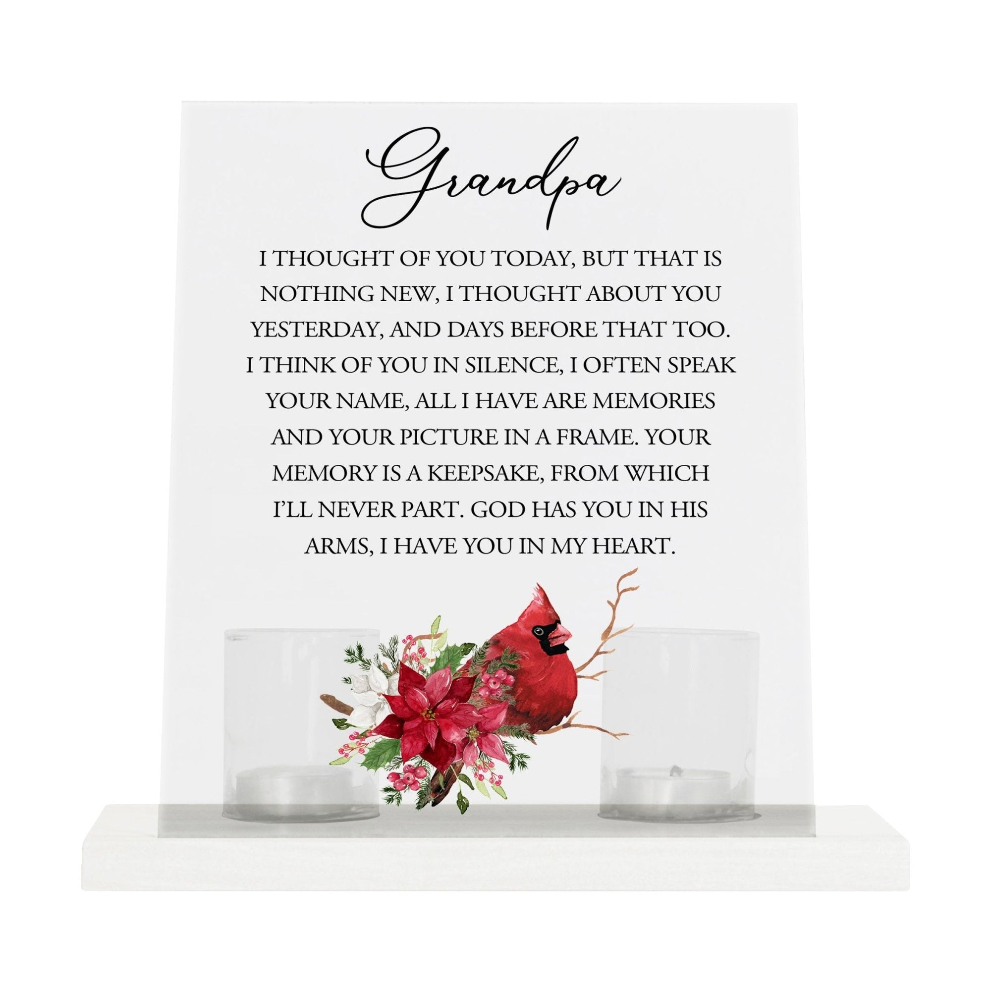 A solemn memorial display featuring a Lifesong Milestones Cardinal Memorial Frosted Acrylic Sign with Base and Votive Candle Holder. The tealight candle holder provides a warm glow, while votive candles surround it, creating a touching memory.