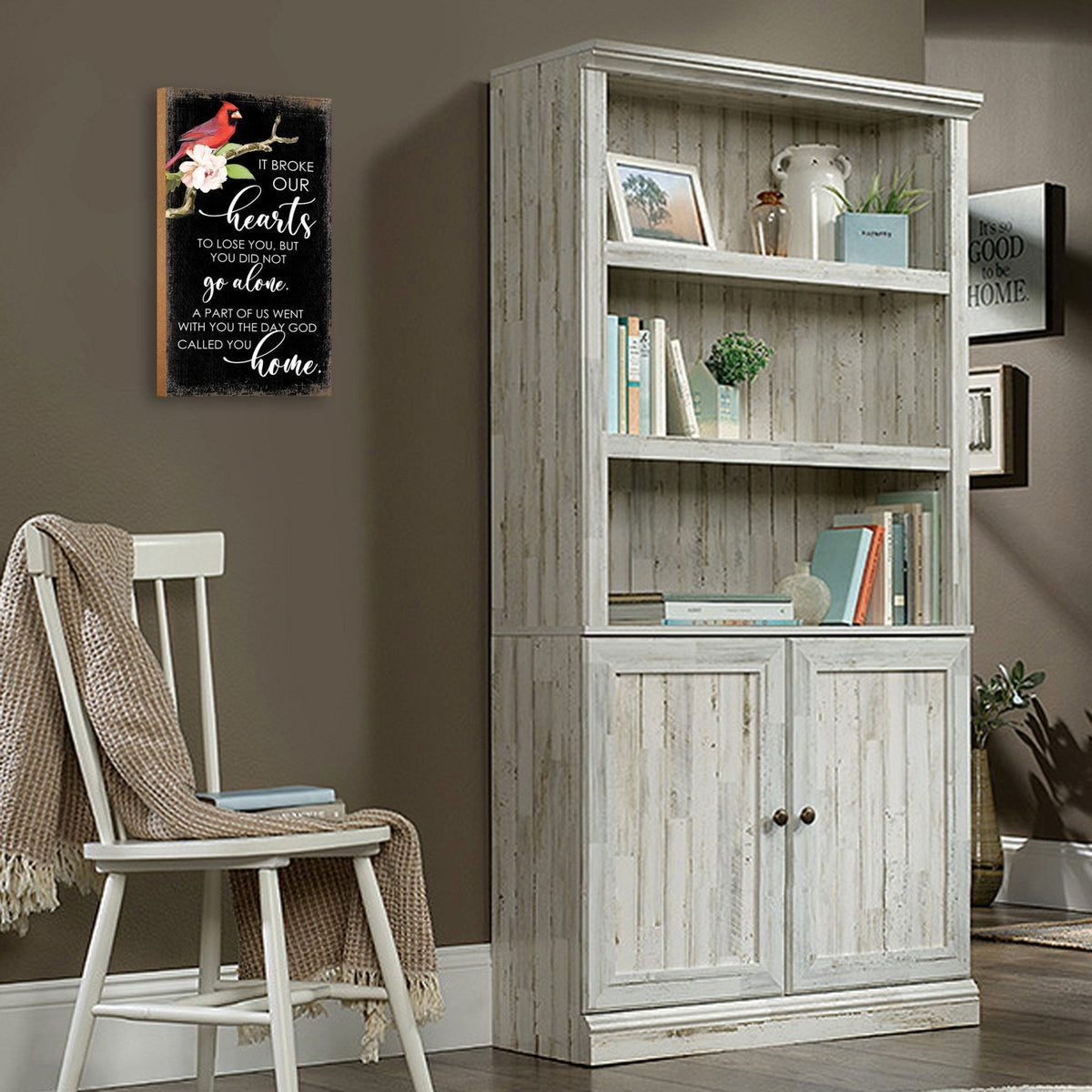 A wooden memorial wall plaque featuring a cardinal, a symbol of remembrance and love.