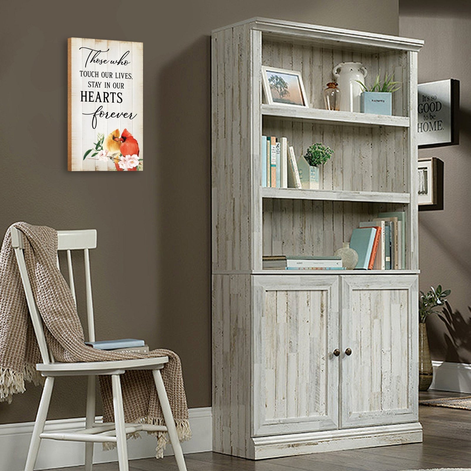 A wooden memorial wall plaque featuring a cardinal, a symbol of remembrance and love.