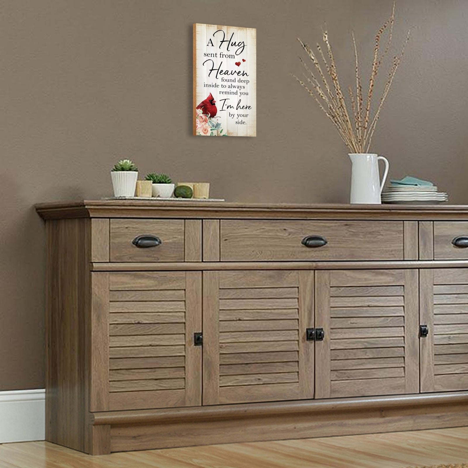 A wooden memorial wall plaque featuring a cardinal, a symbol of remembrance and love.