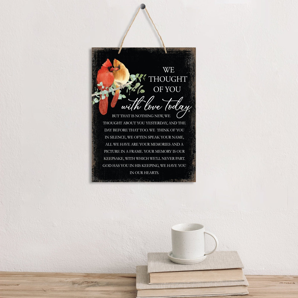 Thoughtful memorial gifts for the loss of a loved one – a wooden hanging sign adorned with a cardinal ribbon.