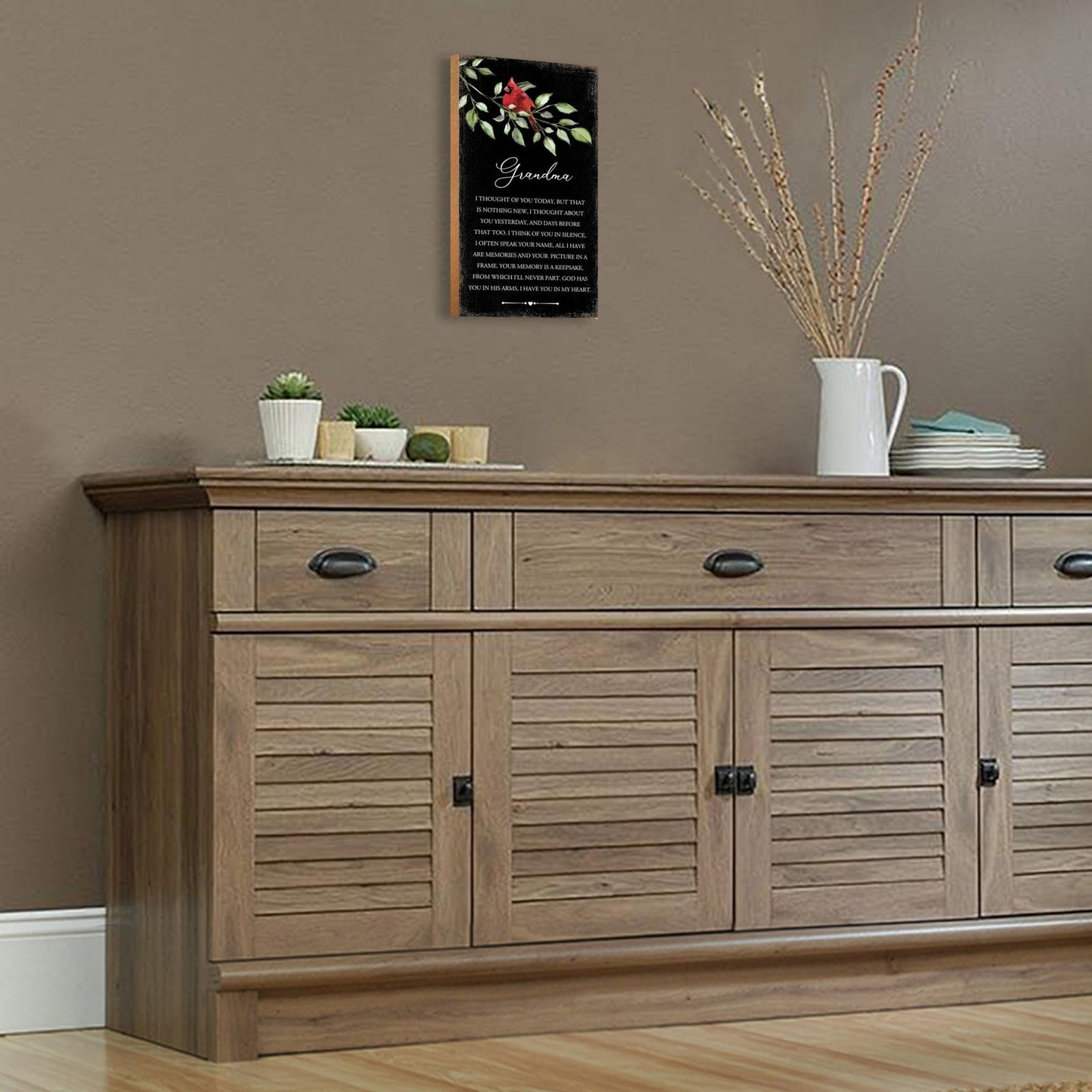 A wooden memorial wall plaque featuring a cardinal, a symbol of remembrance and love.