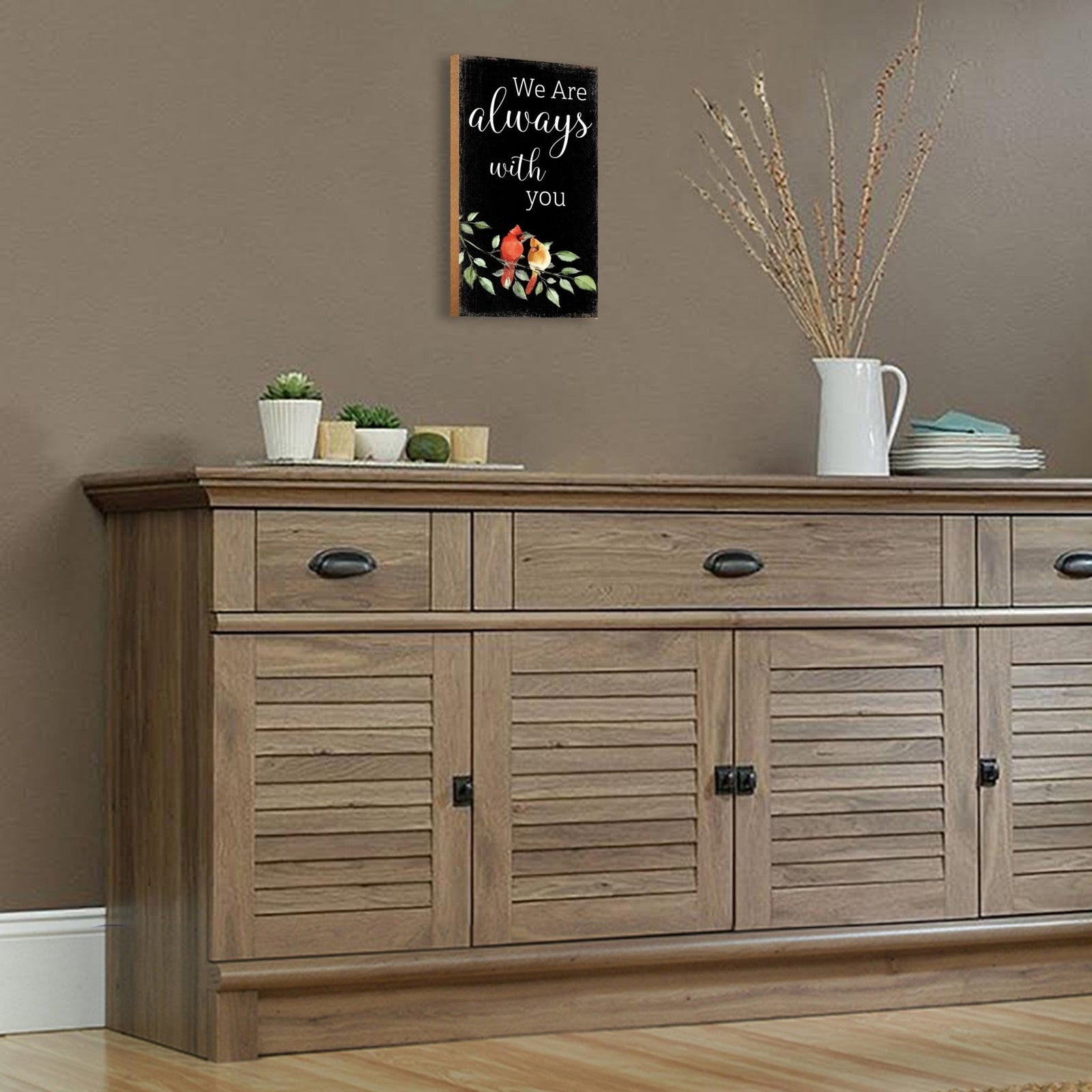 A wooden memorial wall plaque featuring a cardinal, a symbol of remembrance and love.