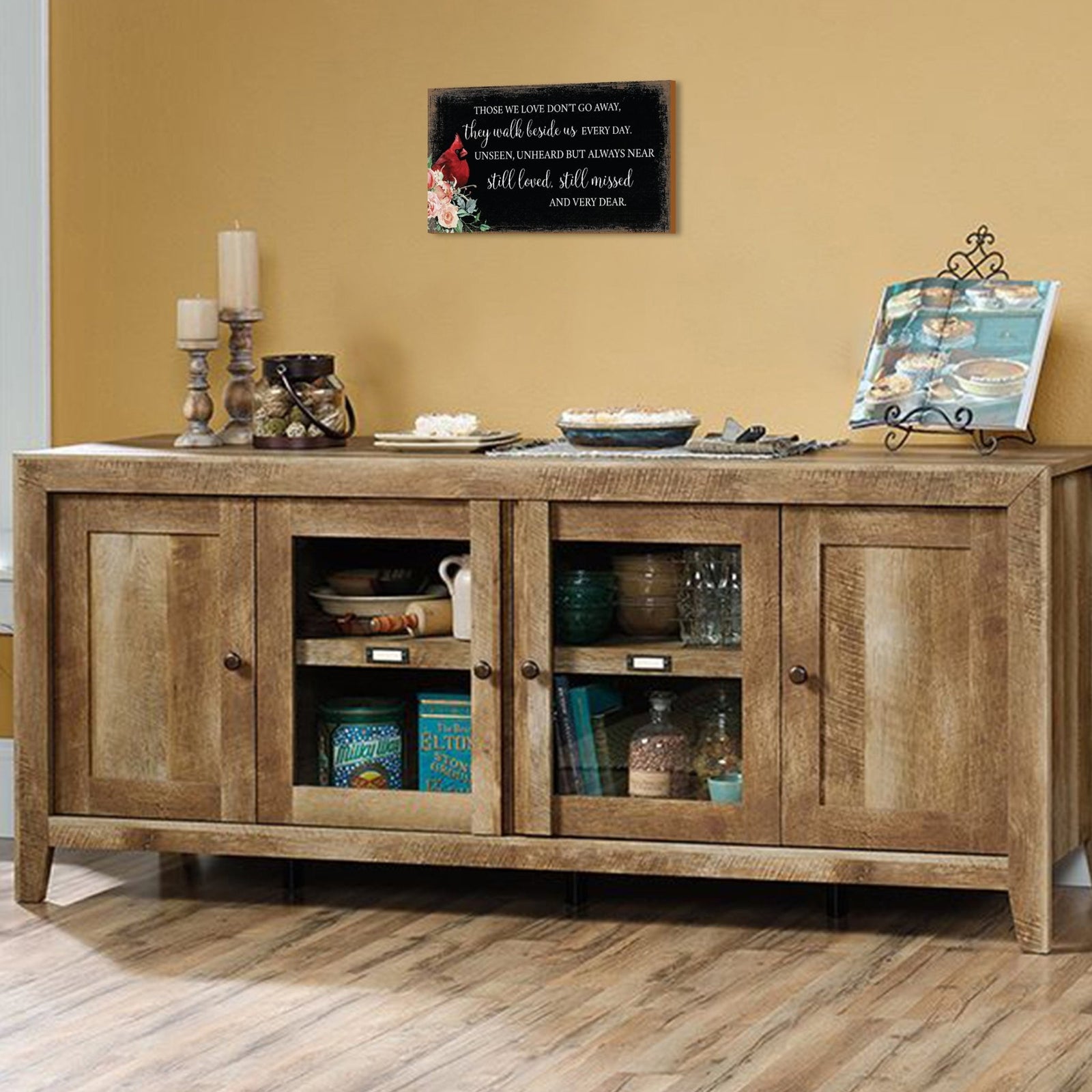 A wooden memorial wall plaque featuring a cardinal, a symbol of remembrance and love.