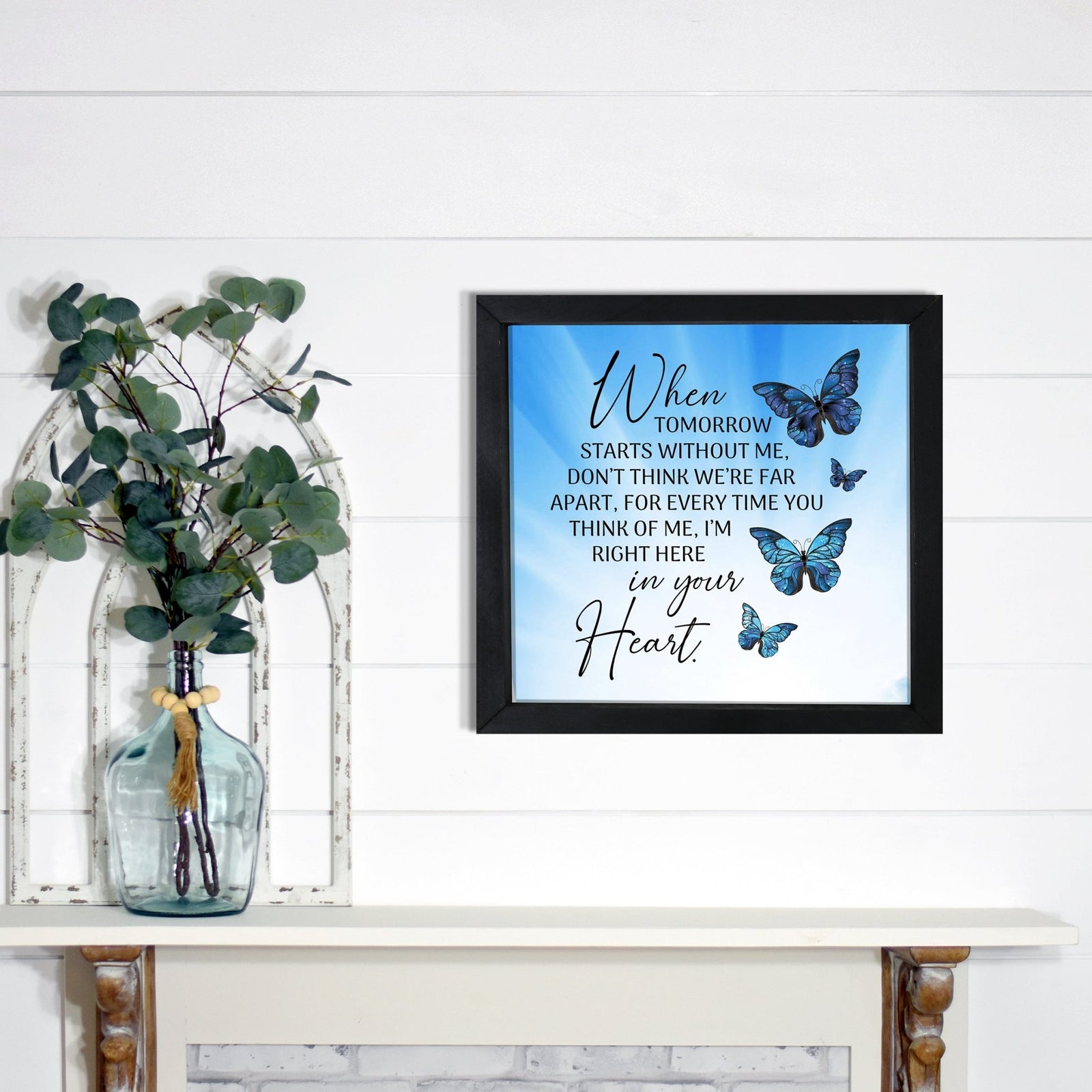 A framed shadow box with a heartfelt memorial tribute inside