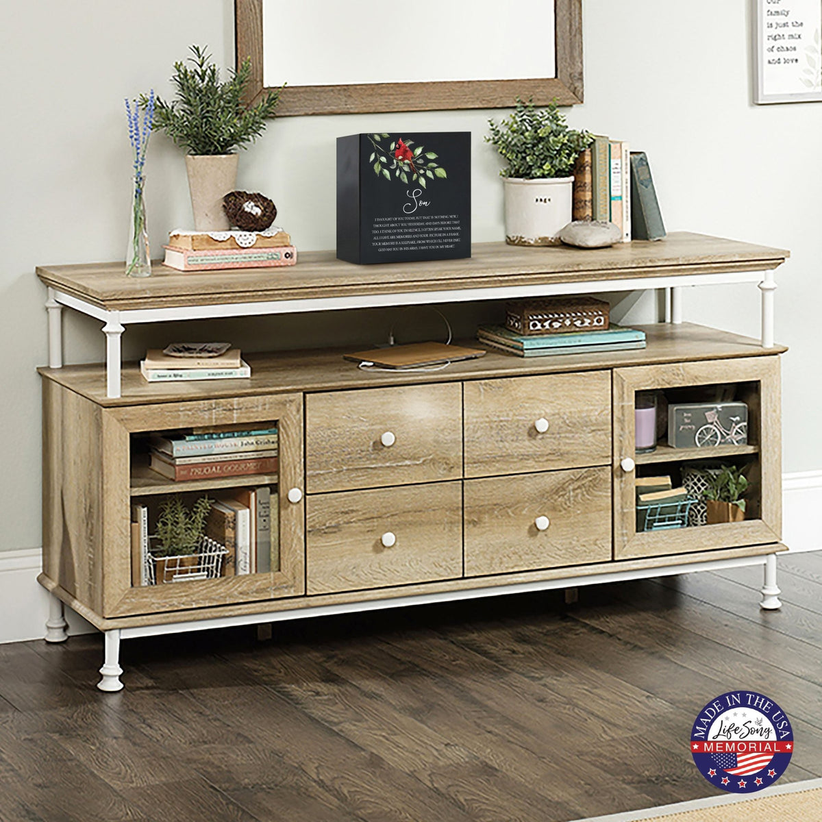 Elegant wooden shadow box urn for son. The urn is displayed on a rustic wooden console table, surrounded by books, plants, and a warm, inviting decor. Perfect for adult cremation keepsakes, combining functionality with heartfelt design.