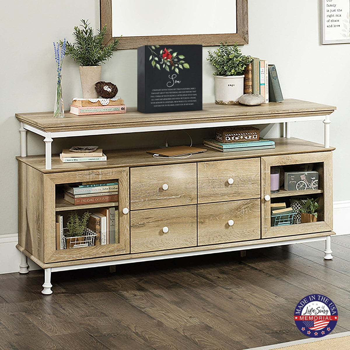 Elegant wooden shadow box urn for son. The urn is displayed on a rustic wooden console table, surrounded by books, plants, and a warm, inviting decor. Perfect for adult cremation keepsakes, combining functionality with heartfelt design.