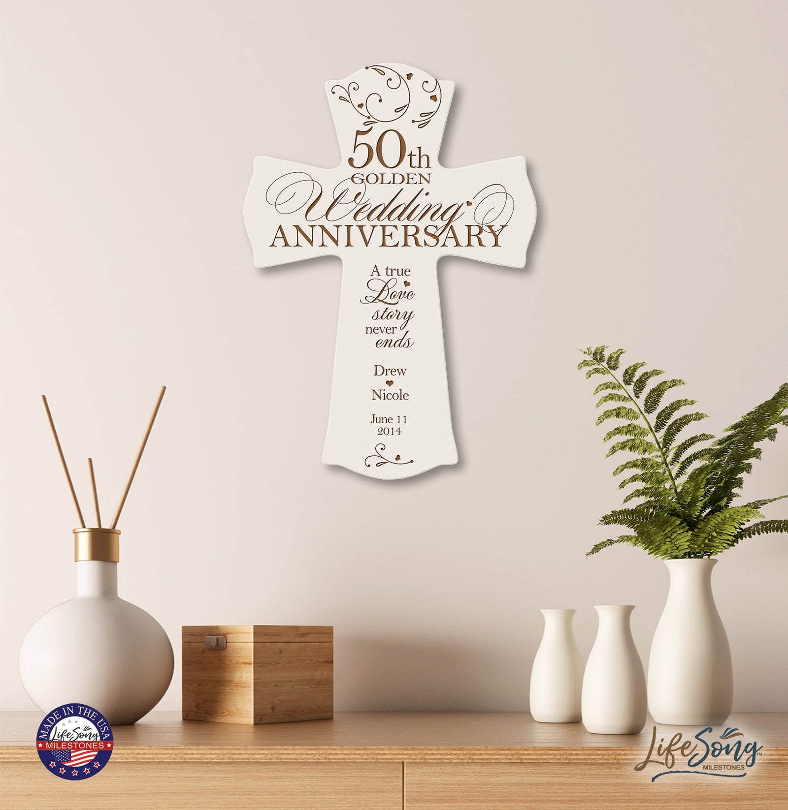 Ivory 50th Golden Wedding Anniversary personalized cross plaque displayed on a modern wooden shelf with decorative vases—custom Christian wall décor featuring names and wedding date.